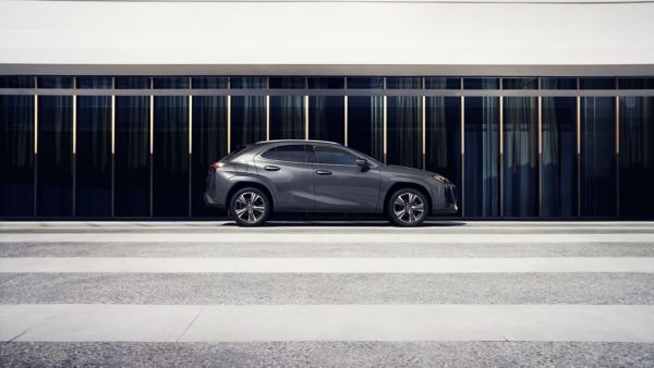  Lexus UX driving down a road