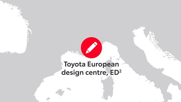Rotes Markierungssymbol, das den Standort des Toyota European Design Centre (ED²) auf einer grauen Karte anzeigt. Der Text lautet „Toyota European design centre, ED²“. Dieses Bild hebt die geografische Bedeutung des Designzentrums innerhalb der europäischen Landschaft hervor und betont seine Rolle bei der Innovation im Automobilbereich.