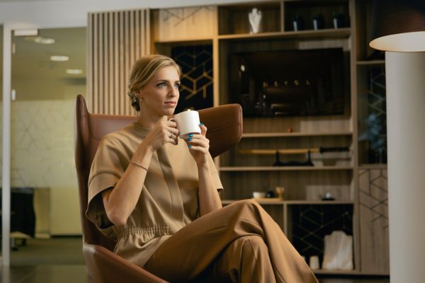 Katrina Lehis sat in a chair holding a mug