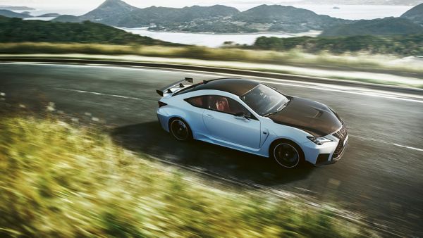 Ein weiß-schwarzer Lexus RCF fährt auf einer Bergstraße