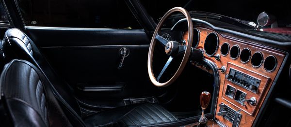 Cockpit des 2000GT mit schwarzen Ledersitzen; Lenkrad, Armaturenbrett und Schaltknauf aus Holz 