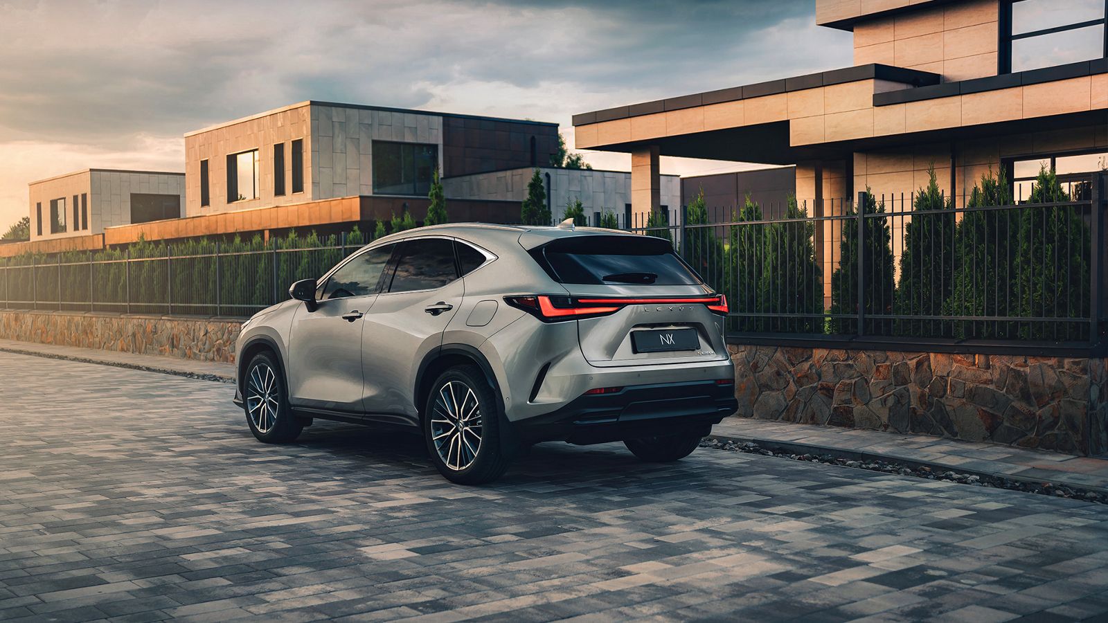 Rear view of a Lexus NX driving on a coastal road