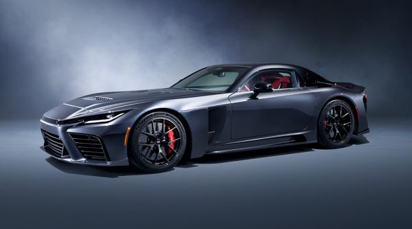 A front three-quarter view of a dark grey Toyota GR GT, shown against a misty grey studio background.