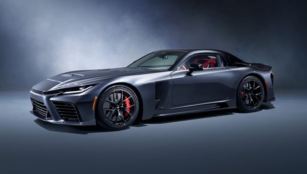 A front three-quarter view of a dark grey Toyota GR GT, shown against a misty grey studio background.