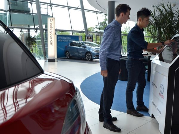 two employees looking at a screen at Toyota head office