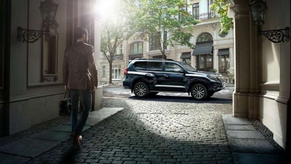 man walking towards Toyota Land Cruiser