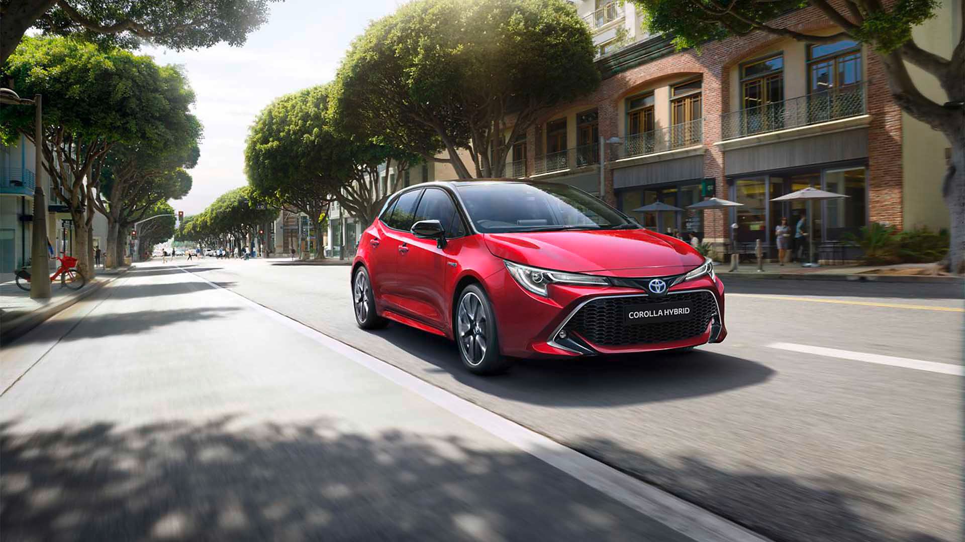 Toyota Corolla Hatchback driving down the road