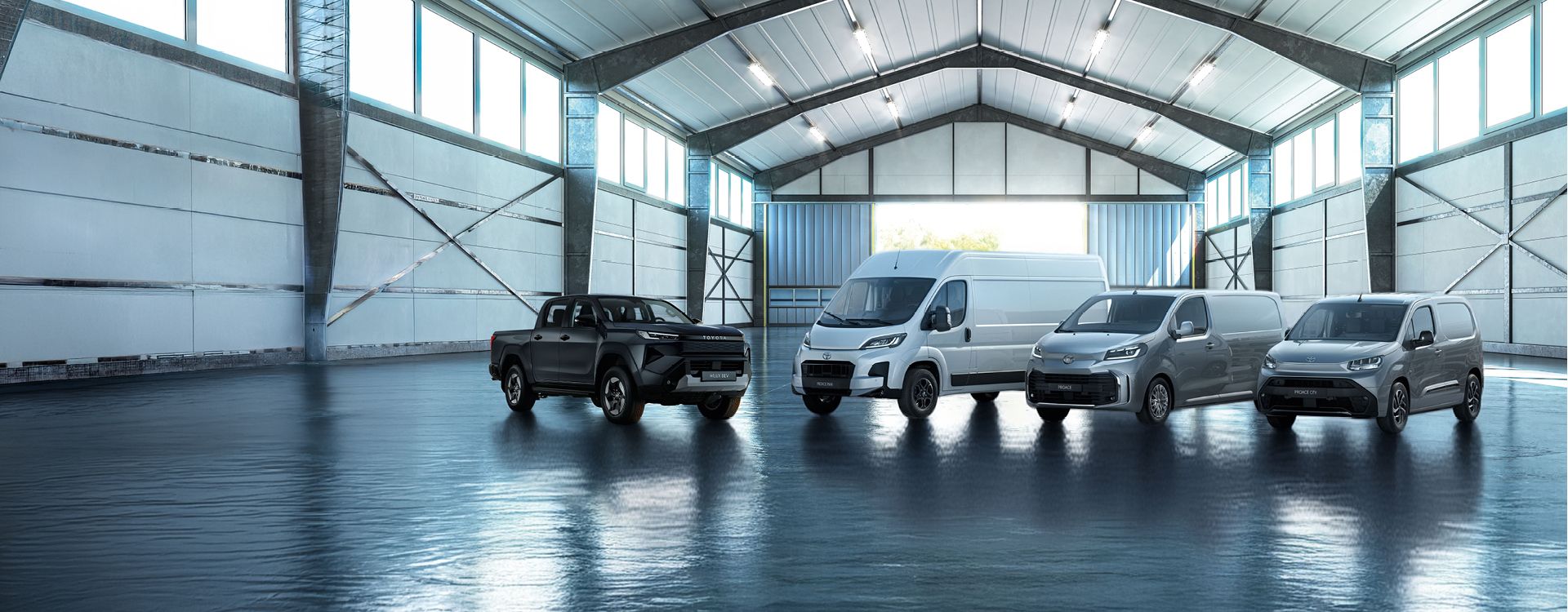 Quatres camionnettes Toyota garés dans un entrepôt.