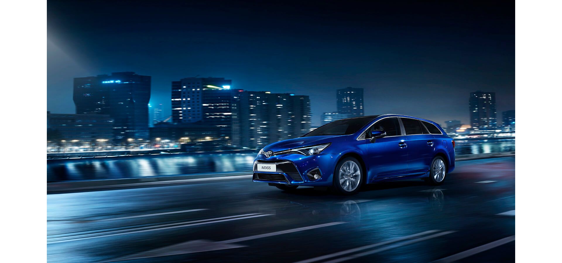 Blue Toyota Avensis driving at night