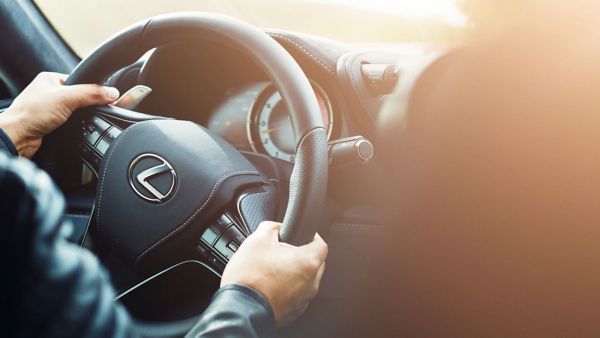 hands on a Lexus steering wheel