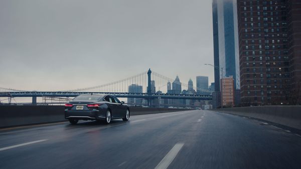 back wide shot of a Lexus LS driving