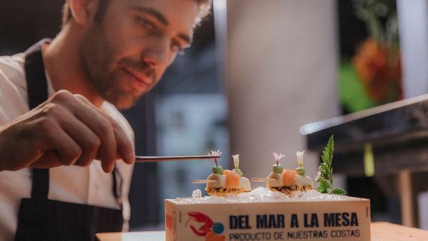 close up of Sergio Barroso plating food