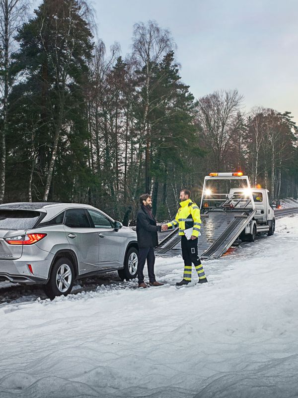 handshake next to a car in snow