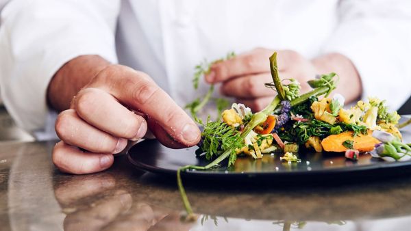 person putting the finishing touches to a recipe Intersect by Lexus New York