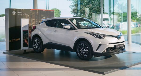 White Toyota C-HR in dealership showroom
