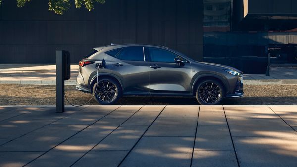 Lexus NX plugged into a charging tower