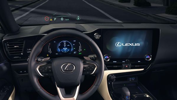 Lexus NX 450+ driving in a city location 