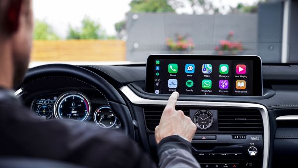 person touching Lexus dashboard