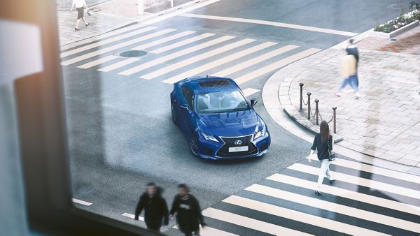 Lexus RC F waiting at a pedestrian crossing