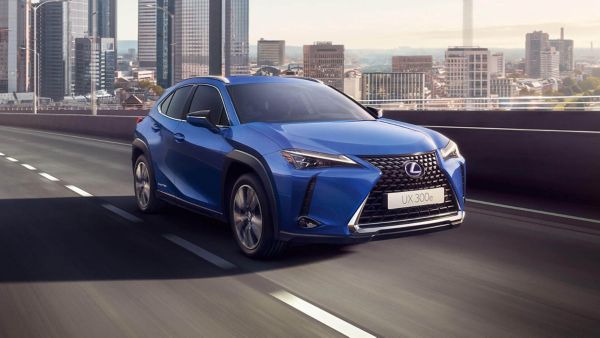A Lexus UX 300e driving in a city location 