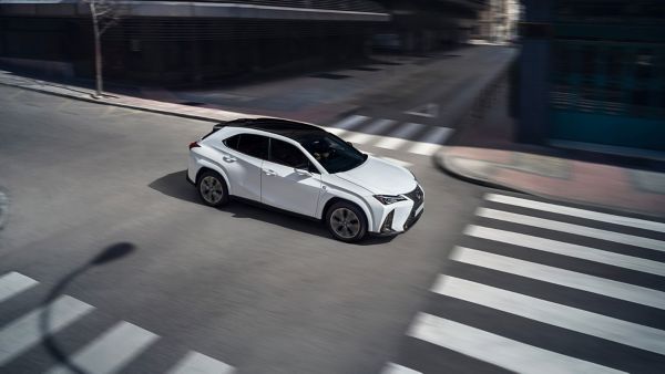 A Lexus UX driving through a junction 