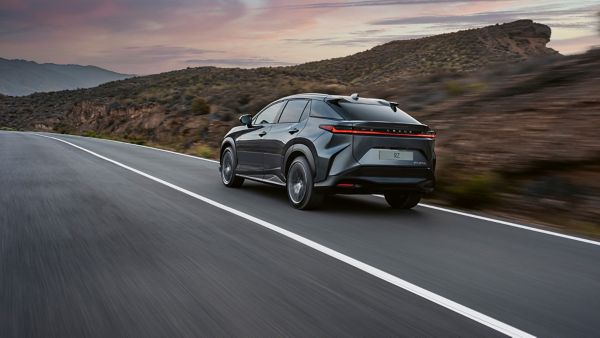 Lexus RZ driving in a rural location