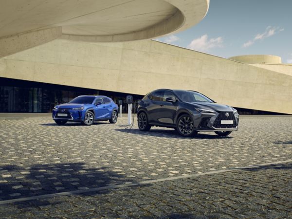 A Lexus UX 300e and Lexus NX plugged into a charging tower 