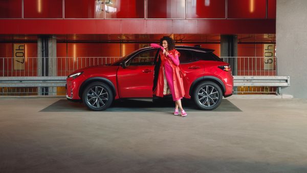 A man walking towards a parked Lexus RX