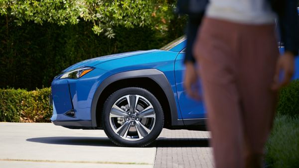 woman next to Lexus car