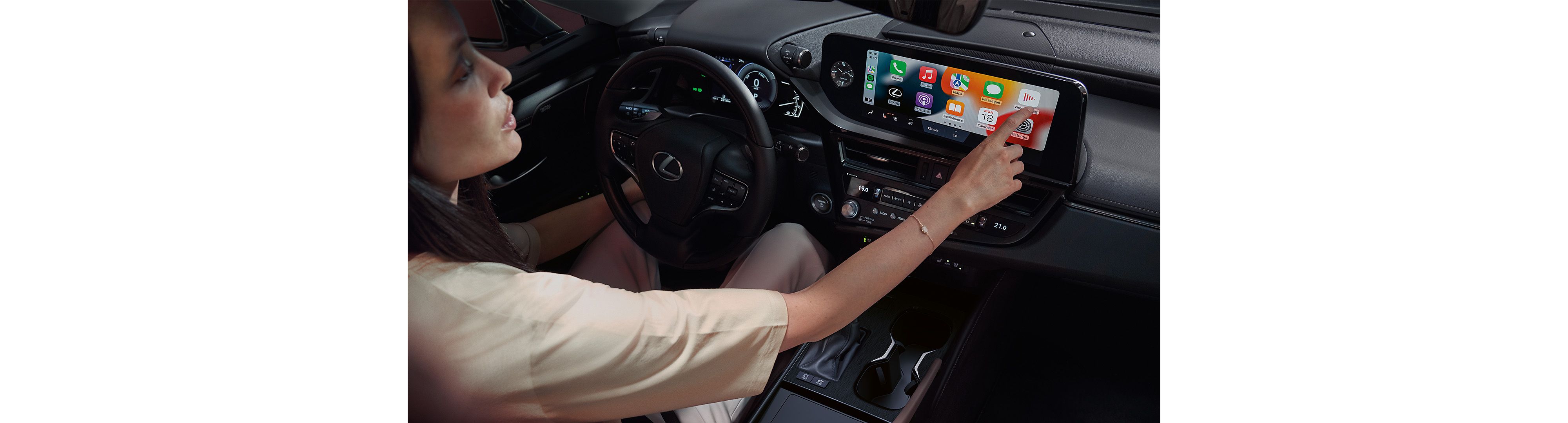 A woman using the multimedia screen within the Lexus ES