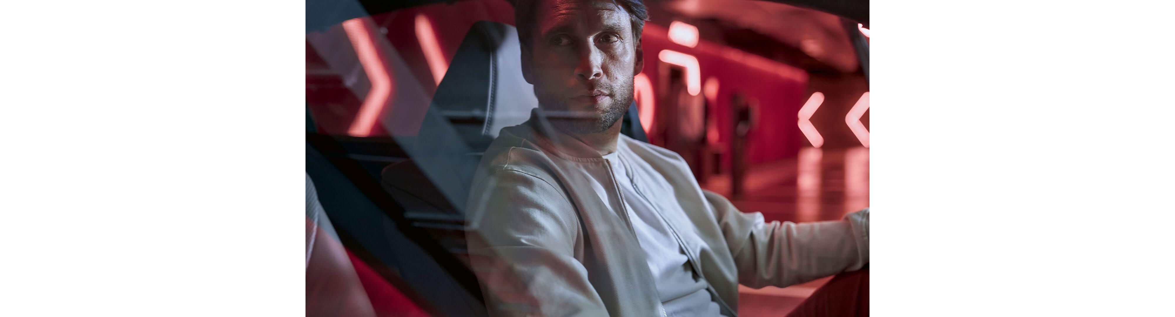 A man sat in a Lexus ES