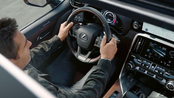 A raised view of a man driving a Lexus LX 