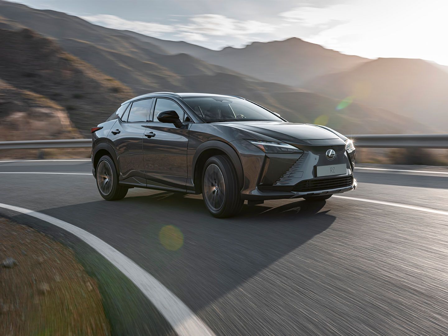 The Lexus RZ driving on a mountain road