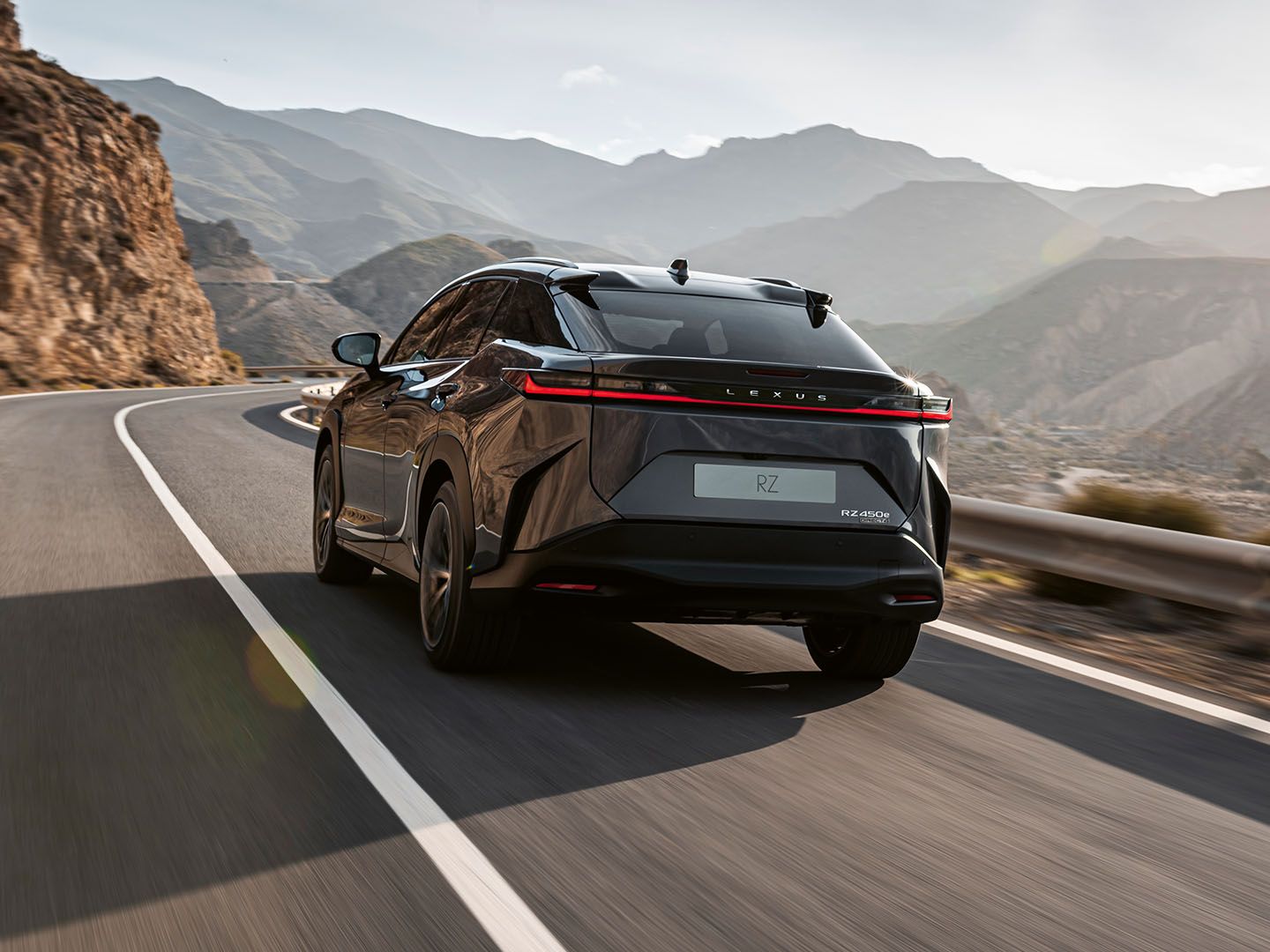 The Lexus RZ driving on a mountain road