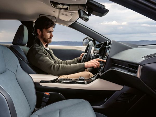 A man sat in a Lexus RZ