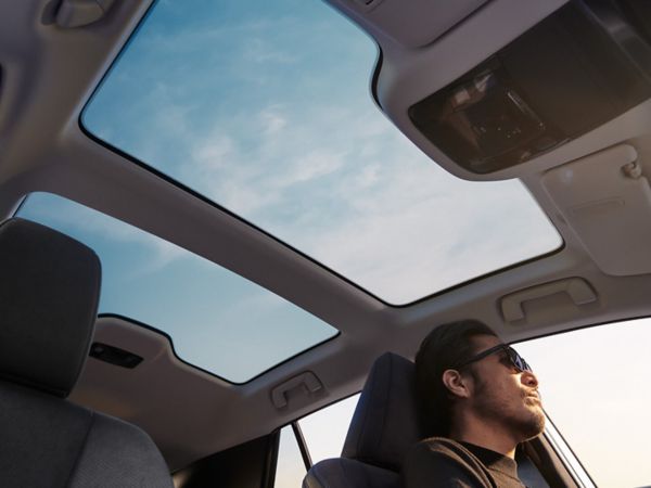 A Lexus UX 300e driving in a city location 