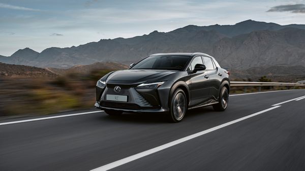 man standing next to a Lexus car