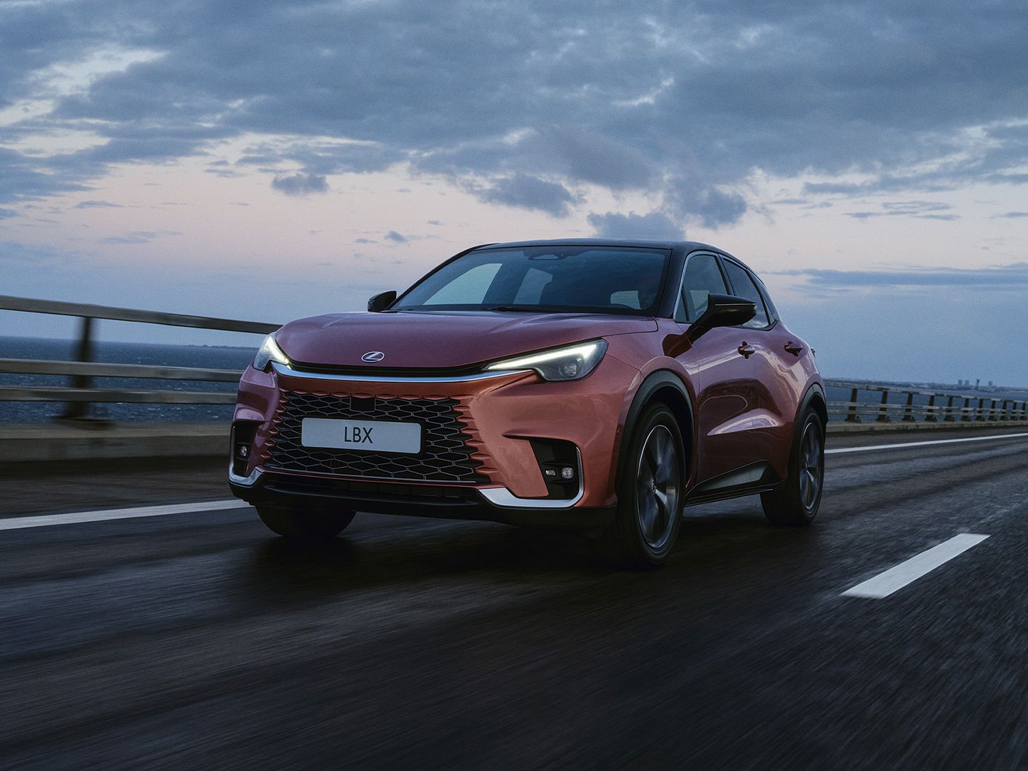 An LBX driving on a coastal road