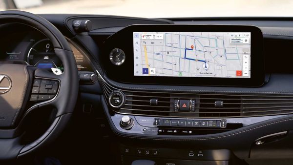 A close up of the steering wheel and multimedia display.