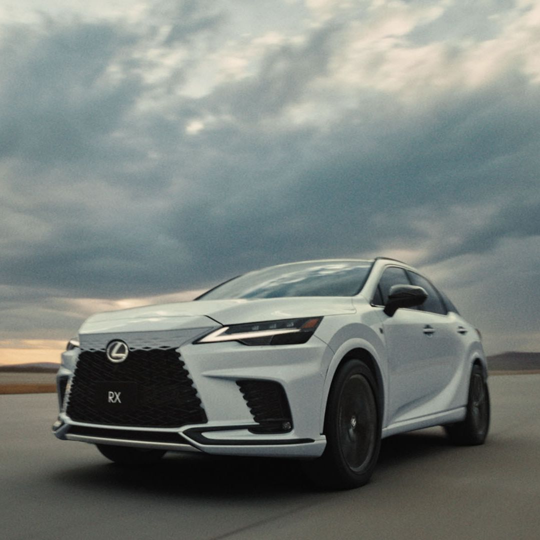 Lexus RX driving on a scenic road