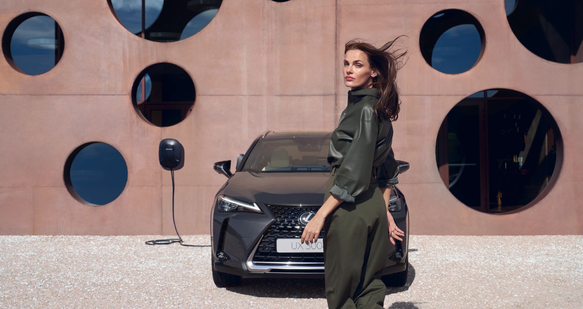 A person stood in front of the Lexus UX