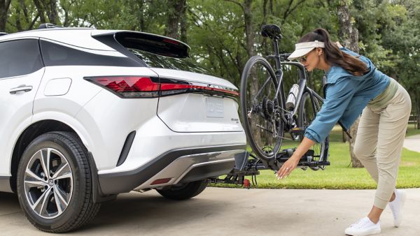 A person securing a bike rack onto a Lexus RX