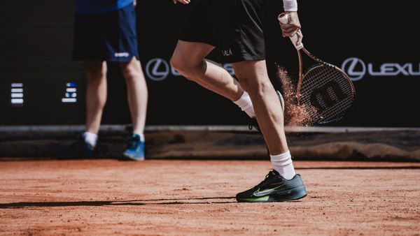 A tennis player serving on court