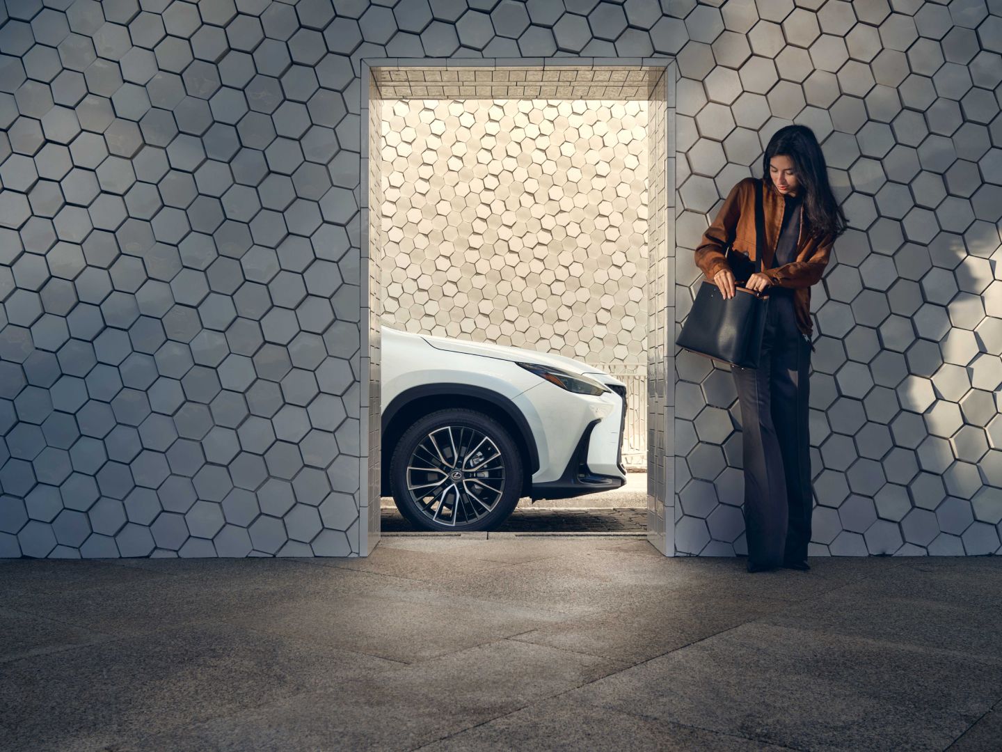 A person stood in the foreground of a Lexus