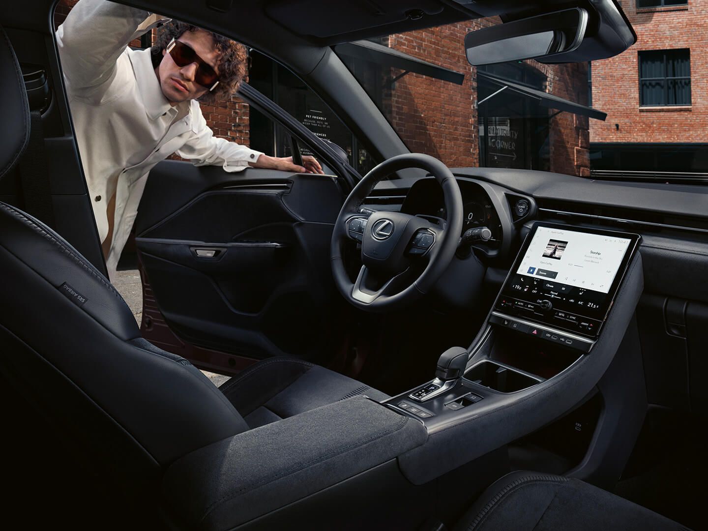 A man looking inside the Lexus LBX model