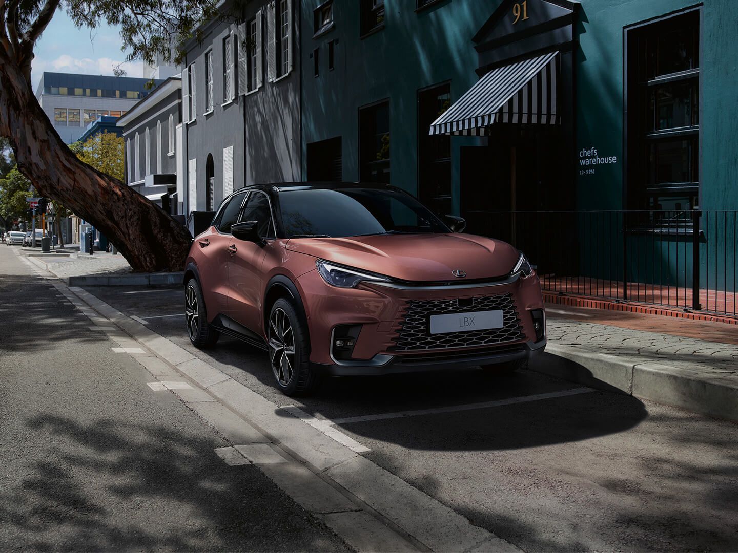 A parked Lexus LBX on a street showcasing its sleek design.