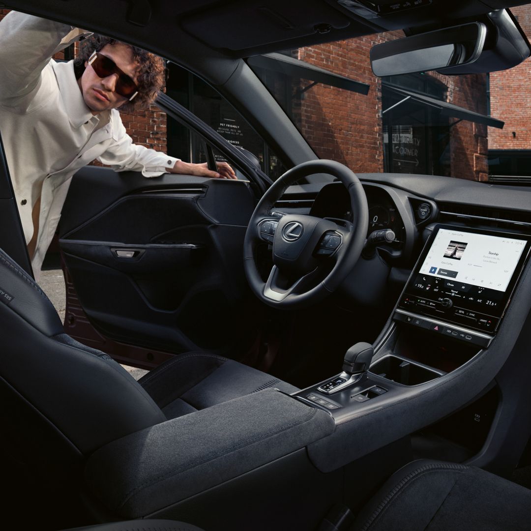 A person in the doorway of a Lexus LBX