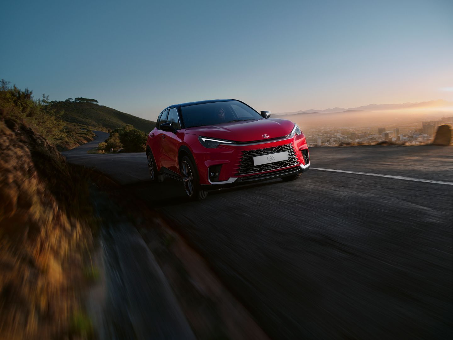 Lexus LBX driving on a hillside road