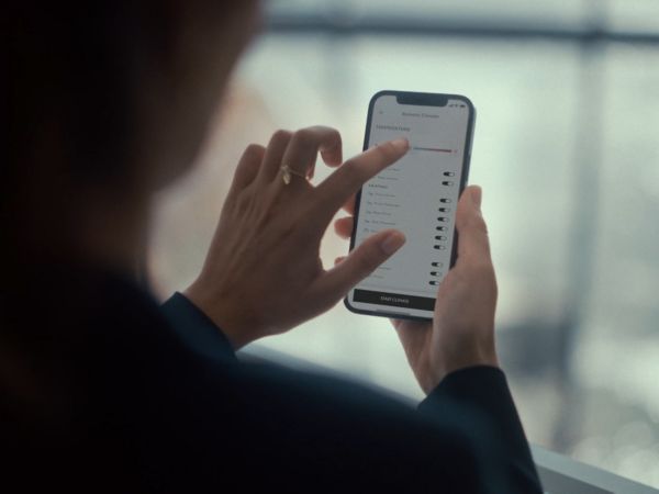 A person using a mobile phone to access the Lexus Link app