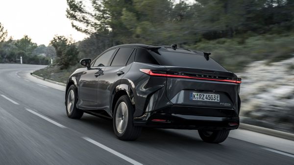 Lexus RZ driving on a hillside road